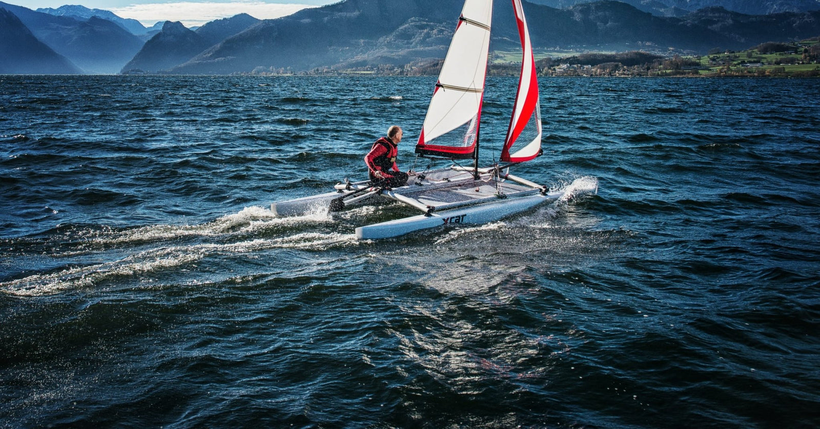 XCAT Multi-Sport Catamaran sailing on a lake